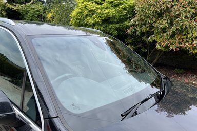 A saint gobain front windscreen ready for replacement after 3 long cracks